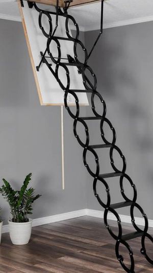 A black concertina loft ladder folded down from a ceiling hatch.